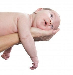 newborn baby on parent's hands