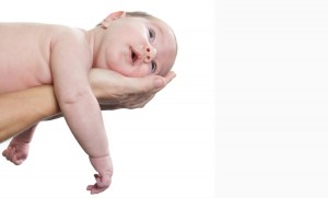 newborn baby on parent's hands